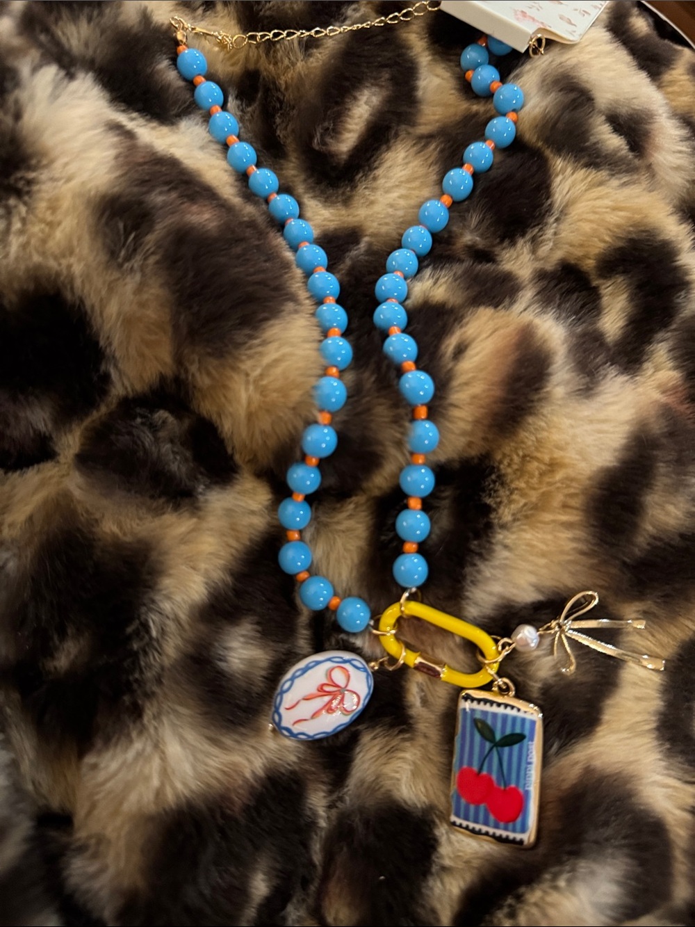 Blue Beaded Necklace with Cherry Charm and Yellow Accents - Women's Jewelry